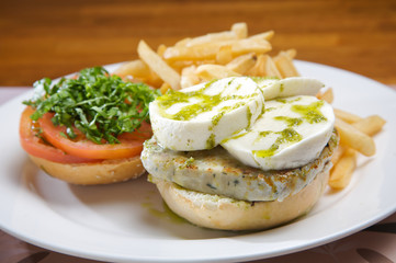 Turkey burger with goat cheese and olive oil. served with french fries.