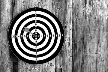 Bullseye is a target of business. Dart is an opportunity and Dartboard on old wood background