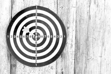 Bullseye is a target of business. Dart is an opportunity and Dartboard on old wood background