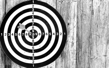 Bullseye is a target of business. Dart is an opportunity and Dartboard on old wood background