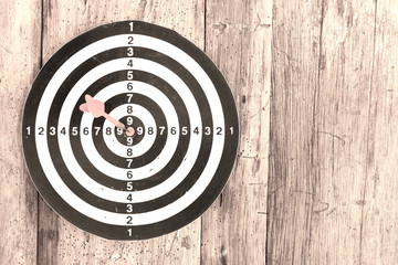 Bullseye is a target of business. Dart is an opportunity and Dartboard on old wood background
