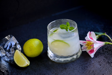 glass of water and lemon on wooden table