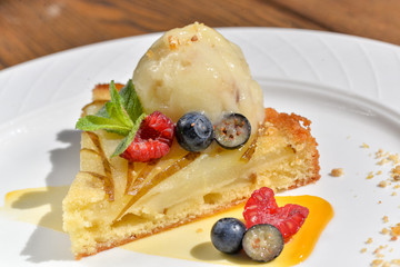 apple pie with ice cream and berries in a plate