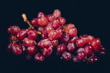Red grape isolated on black Background.
