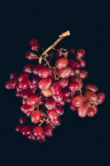 Red grape isolated on black Background.