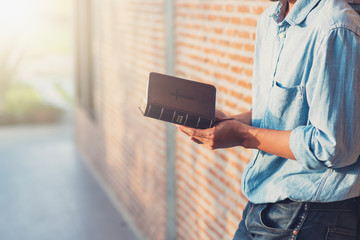 Praying hands of young man with Bible , pray to God and  hoping for better,success, forgiveness. Power of religion, belief, worship.Bible and christian study concept