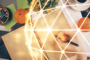 Social network theme hologram over hands taking notes background. Concept of global international people connect. Double exposure