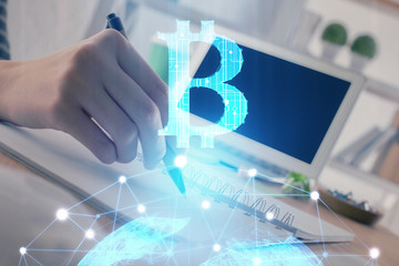Cryptocurrency hologram, bitcoin, ico theme over hands taking notes background. Concept of blockchain. Multi exposure