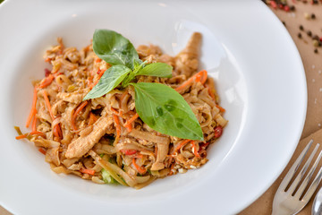 pasta with chicken and vegetables decorated with basil