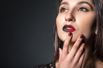 Glamour fashion model portrait with dark lips and nails