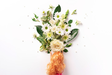 Doll head with white flowers. Bridal hairstyle. Creative layout. Spring and summer concept