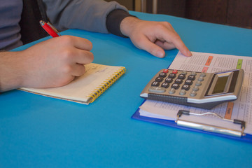 Businessman hand using calculator, accounting concept. Man hands with pencil, notebook and Calculator