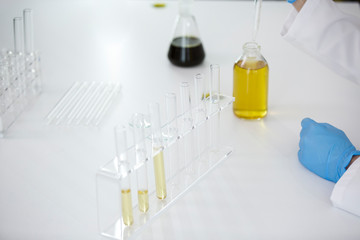 Scientist tearing the CBD oil from one tube into another