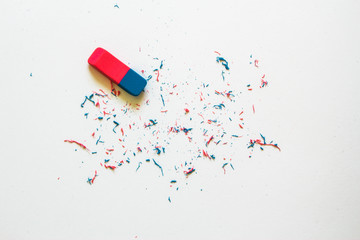 Pink and blue eraser and it’s shavings sitting on a clean white sheet of paper with copy space – Small office supply for correcting errors – Concept image for erasing mistakes and editing - 269420875