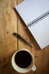  Flay lay space on the desk Area space enter text. dark coffee cups, Pen note paper Placed on an old wood texture top view desk table with top view with copy space 