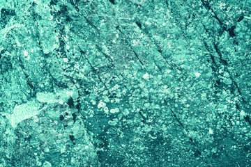 Vintage azure background. Rough painted wall of turquoise color. Imperfect plane of cyan colored. Uneven old decorative toned backdrop of aqzure tint. Texture of teal hue. Ornamental stony surface.