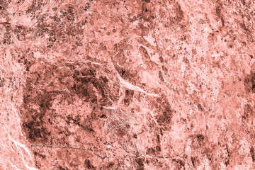 Vintage pink background. Rough painted wall of living coral color. Imperfect plane of beige colored. Uneven old decorative toned backdrop of beige tint. Texture of pink hue. Ornamental stony surface.