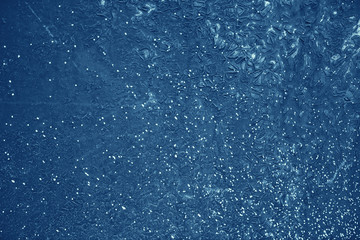 Vintage blue background. Rough painted wall of sapphire color. Imperfect plane of blue colored. Uneven old decorative toned backdrop of cyan tint. Texture of sapphirine hue. Ornamental stony surface.