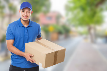 Young latin man delivering parcel delivery service package order job education town copyspace copy...