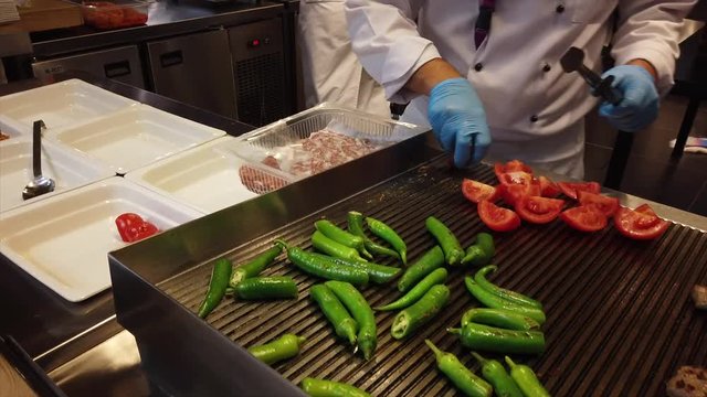 Making Turkish Tavuk step 2 grilling tomatoes.