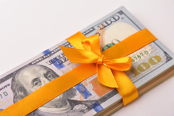 Dollar banknotes and yellow bow