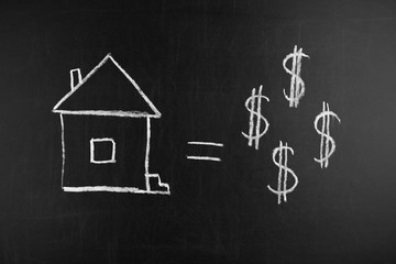 Home figure and dollar symbols drawing chalk on blackboard