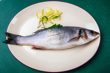 fresh sea bass on a white plate