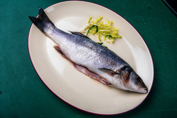 fresh sea bass on a white plate