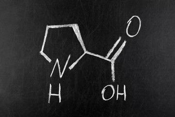 Fototapeta na wymiar Proline (l-proline, Pro) amino acid molecule on blackboard