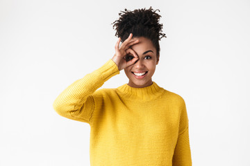 Image closeup of positive african american woman looking at camera and showing ok sing