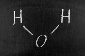 Water (H2O) molecule on blackboard