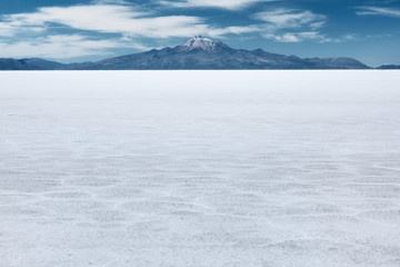 The world's largest salt flat and dormant volcano Tunupa at the far background, Salar de Uyuni, Bolivia 
