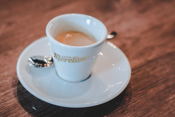 Barista making freshly dripped single espresso in an espresso machine