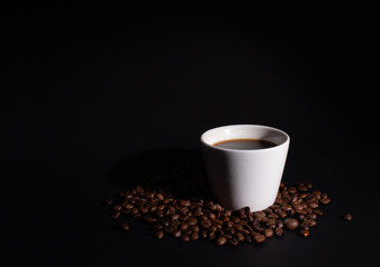 Side light on a white cup set in coffee grains