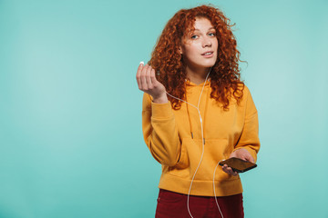 Portrait of an attractive redhead young woman standing