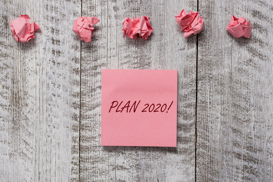 Word writing text Plan 2020. Business photo showcasing detailed proposal for doing or achieving something next year Thick set of plain note paper with scraps on the wooden textured table