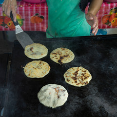 Person baking Pupusas, a traditional flatbread, San Ignacio, Belize