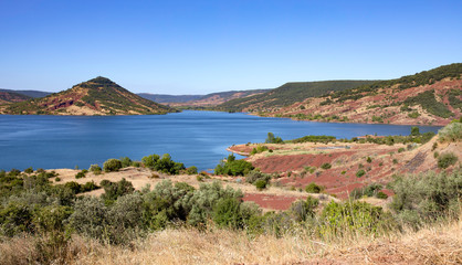 Lake Salagou (Lac du Salagou) France. Wide panorama, calm water and colorful hills.