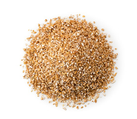 Heap of dry wheat groats on a white background. The form of the top.