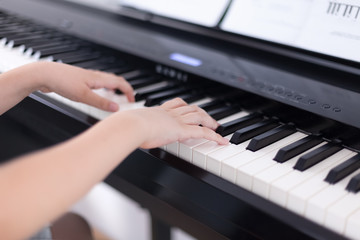 Fototapeta na wymiar Young boy playing on a digital piano