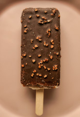 Chocolate popsicle ice cream isolated on pink background