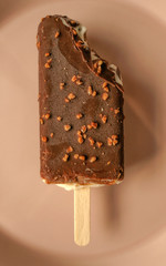 Chocolate popsicle ice cream isolated on pink background