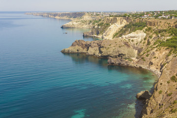 Obraz premium Rocky steep shore of the blue Black sea. The Western part of the Crimean Peninsula.