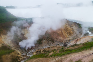Fototapeta na wymiar A small valley of geysers near the Mutnovsky geo power station in Kamchatka