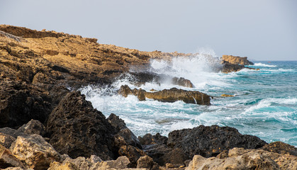 Sea waves crash onto rocks at Apostolos Andreas beach in Karpasia, Cyprus