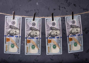 Money Laundering. Money Laundering US dollars hung out to dry. 100 dollar bills hanging on...