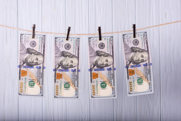 Money Laundering. Money Laundering US dollars hung out to dry. 100 dollar bills hanging on...