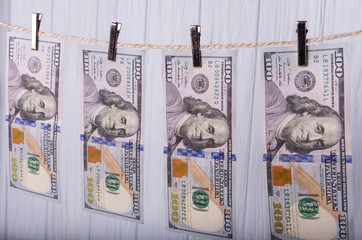 Money Laundering. Money Laundering US dollars hung out to dry. 100 dollar bills hanging on...