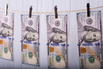 Money Laundering. Money Laundering US dollars hung out to dry. 100 dollar bills hanging on...