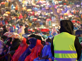 man with yellow jacket during live event